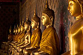 Bangkok Wat Arun - The covered passageway around the ubosot is lined with 120 Buddha statues in the sitting position.  